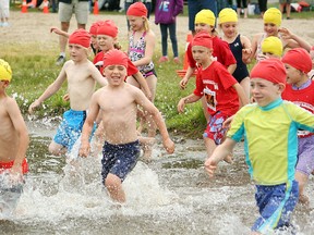 Six- and seven-year-old racers plunge into Trout Lake for the start of the Viola Burke Kids Triathlon Saturday at Olmsted Beach. Youth triathletes from across Ontario took part in the annual race, which kicks off the two-day triathlon weekend.