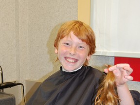 Ethan Mudford of Tillsonburg shows off his nine-inch ponytail that was cut on Friday at First Choice Haircutters in Tillsonburg. Mudford is donating the hair to the Canadian Cancer Society and will be used to make wigs for children and adults with cancer. 

KRISTINE JEAN/TILLSONBURG NEWS/QMI AGENCY