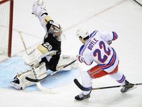 Pittsburgh Penguins goaltender Marc-Andre Fleury makes a save on New York Rangers forward Brian Boyle during NHL action in Pittsburgh,  April 5, 2013. (REUTERS/David A. DeNoma)
