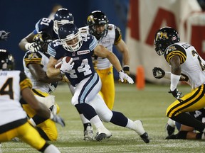 Argonauts running back Chad Kackert breaks free through the Tiger-Cats’ line during fourth-quarter action Friday night at the Rogers Centre. (Craig Robertson/Toronto Sun)