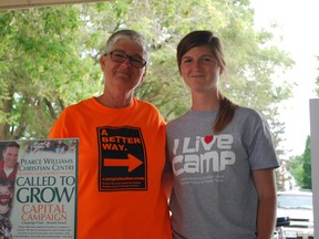 Sandi Pyper, left, stands with daughter Meagen during a stop in St. Thomas on Saturday, June 29, 2013. Pyper is walking about 350 km across Elgin County to promote the county and raise awareness about a Christian centre's capital campaign. Ben Forrest/QMI Agency/Times-Journal