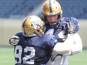 Winnipeg Blue Bombers defensive end Zach Anderson (r) works out against Winnipeg Blue Bombers defensive tackle Bryant Turner during CFL football practice in Winnipeg, Man. Sunday June 30, 2013.
BRIAN DONOGH/WINNIPEG SUN/QMI AGENCY