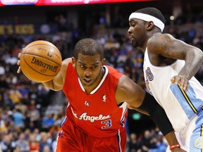 Los Angeles Clippers' Chris Paul (L) tries to get past Denver Nuggets' Ty Lawson during their NBA basketball game in Denver March 7, 2013. (REUTERS/Rick Wilking)