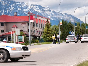 RCMP gather in front of the Chateau Canmore on Bow Valley Trail after a bomb threat on Wednesday, June 26, 2013. RCMP officers were on the scene for close to four hours. Pam Doyle/ For the Crqag & Canyon