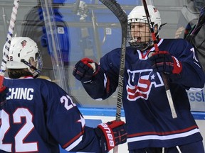 U.S. forward Tyler Motte, right, celebrates scoring against team Sweden during a quarter-final game of the IIHF U18 International Ice Hockey World Championship in Soch, Russia on April 25, 2013. The 18-year-old was selected 121st overall by the Chicago Blackhawks in Sunday's NHL draft and could play in Sarnia next season if the team wants him to develop in Ontario.  (AFP PHOTO / ALEXANDER NEMENOV)