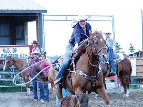 Quinn Hawk  has a time of 4.7 seconds in the breakaway roping in theJune 29 Nanton Nite Rodeo.