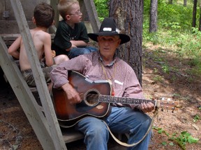 Bob Neufeld plays the guitar for children at the Camp Wapiti 50th Reunion camp-out grounds on Saturday. Campers pitched tents at Camp Wapiti, founded in 1963, for the long weekend to celebrate nature. (Caryn Ceolin/Daily Herald-Tribune)