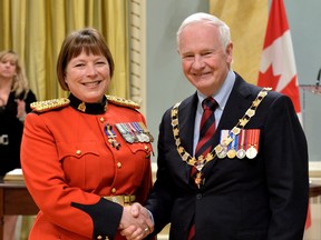 Governor General David Johnston presents The Order of Merit of the Police Forces, Member insigna to Chief Superintendent Brenda M. Lucki, M.O.M., at Rideau Hall in Ottawa on May 24. (Photo courtesy of Sgt. Ronald Duchesne)