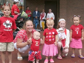 Among those who braved wet conditions to watch the Canada Day Parade were, from left: Denver Rice, 5, Joscelynne Leach, her son Thomas Leach, four months, Carysse Leach, 2, Sydney Cooper, 9, who doll was dressed for the occasion, and Celynne Leach, 3.