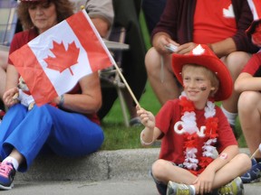 Jonah Earle, 8, smiles as he watches the Canada Day parade pass along Christina Street in Sarnia, Monday. The Sarnia youngster was among thousands of people enjoying Canada's 146th birthday bash. TYLER KULA/ THE OBSERVER/ QMI AGENCY
