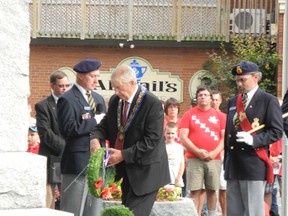 Brant County Mayor Ron Eddy places a wreath at the St. George Cenotaph on Canada Day. He was participating in a ceremony to rededicate the cenotaph which was organized by the South Dumfries Historical Society. (VINCENT BALL Brantford Expositor)