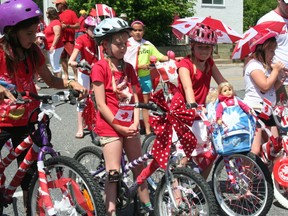 Four contestants in the children's bike decorating contest show off their newly made-over bicycles to the Ladies of the Royal Purple. Dozens of children showed up for the contest which awarded cash prizes, before hitting Ottawa St. for the Canada Day parade on Monday, July 1. 
GRACE PROTOPAPAS/KENORA DAILY MINER AND NEWS