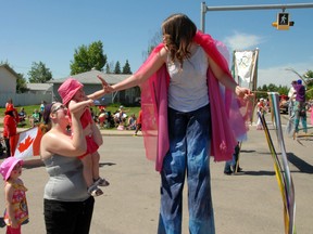 Haylie Lafortune, 22 months, snags a high five during the Canada Day parade along 108 Ave., on Monday, July 1, 2013. Grande Prairie celebrated the country's 146th birthday with the annual parade, which unionized the community's spirit with national pride. Family-friendly festivities followed at Muskoseepi Park. CARYN CEOLIN/HERALD-TRIBUNE/QMI AGENCY