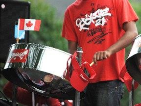 Kenrick Dookie, 28, plays a steel drum as his family's Pan Wave Steel Band plays in Sarnia's annual Canada Day parade. The Cambridge-based band was new to the Sarnia parade this year. TYLER KULA/ THE OBSERVER/ QMI AGENCY