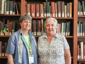 Joanne Stanbridge and Joyce Fingland stand in the Geneology and Local History section of the Kingston Library. (Sam Koebrich/For The Whig-Standard).