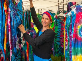 Gaia Orion displays some of the tie-dye apparel for sale at her booth during Artfest at City Park on the weekend. (Sam Koebrich/For The Whig-Standard)