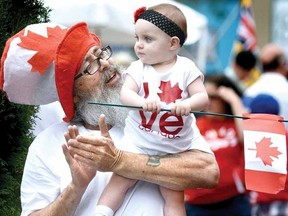 Stratford resident Ken Murray and little next-door neighbour Blake Bontaine, one year, take in the Canada Day festivities in the city's downtown Monday. (SCOTT WISHART The Beacon Herald)