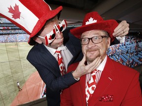 Rogers Sportsnet’s dynamic duo of baseball — Gregg Zaun (sitting) and Jamie Campbell — take in Canada Day to the max. (Craig Robertson/Toronto Sun)