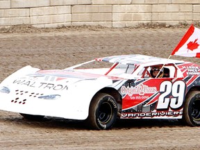 Merlin's Eren Vanderiviere waves the Canadian flag during a pre-race ceremony Saturday at South Buxton Raceway. (JAMES MACDONALD/Special to The Daily News)