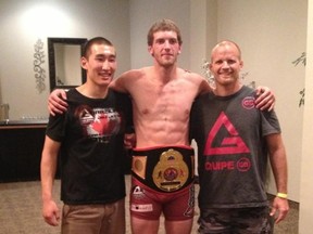 Nick Whittal, centre, celebrates his Triple X Cagefighting championship Saturday with Gracie Barra Chatham coaches. (Contributed Photo)