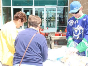 Mustangs defenseman Jay Aasen helped out during the Melfort Mustangs season ticket early bird blitz barbecue at the Northern Lights Palace on Thursday, June 27.