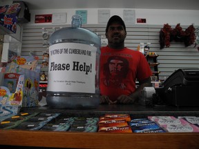 Arjuna Balasubrahamniam mans the counter at A-Z Convenience, a shop on the corner of Fourth and Cumberland Streets that is a depot for donations for the victims of the apartment fire two weeks ago.
CHERYL BRINK/staff photo