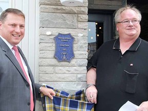 Mayor Dan Mathieson, left, and Stratford Heritage chair Dave Gaffney unveil a plaque Monday at 46 Ontario St. to mark where famous inventor Thomas Edison lived while working on the Grand Trunk Railway at the age of 16. LAURA CUDWORTH/The Beacon Herald