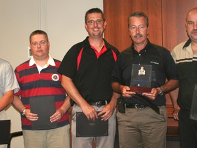 Five employees of Chatham Chrysler received certificates of commendations from the Chatham-Kent Police Service for their role in alerting police about the presence of a U.S. fugitive sex offender in the community when he stopped at the local dealership in April. Pictured from left is: Lloyd Cottel, Steve Melnyk, Matt Picard, Dave Tessier and Steve Hope.
(Don Robinet/ QMI AGENCY)
