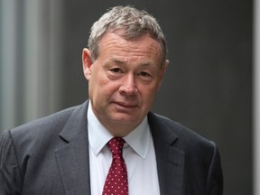 Banker Ian Hannam leaves the High Court in London July 2, 2013.  REUTERS/Neil Hall