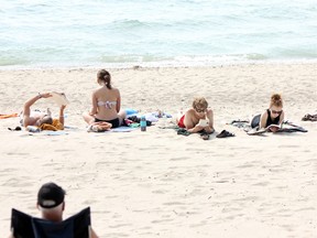 After a cool and unwelcoming spring, visitors and local alike are flocking to Municipality of Kincardine beaches, like Station Beach above, to take advantage of sunbathing opportunities and the increasingly warmer waters of Lake Huron in June and July, 2013. Whether unplugging at Station Beach reading a book like these folks above, or taking a dip in Lake Huron, Kincardine has many recreational opportunities in summer. (TROY PATTERSON/KINCARDINE NEWS)