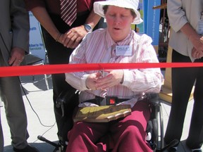 Auxiliary resident Dallas May Thompson cuts the ribbon, officially opening the Mayerthorpe Auxiliary garden.