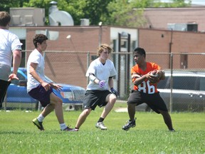 Jackson Penner, centre, and Sebastian Trask, right, in white try to stop a St. John's player from gaining any more yards during the Winnipeg High School Football League's 8 on 8 Passing Tournament. Beaver Brae brought 20 students to Winnipeg for the tournament on Tuesday, June 25.
PHOTO BY VANESSA TRASK