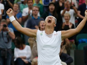 Kirsten Flipkens of Belgium celebrates after defeating Petra Kvitova of the Czech Republic in their women's quarterfinal match at Wimbledon  in London July 2, 2013. (REUTERS/Suzanne Plunkett)