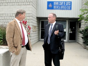 Dr. David Colby, left, talked to his lawyer, David Kinwin outside the Ontario Court of Justice provincial offences court near Blenheim, Ontario. (VICKI GOUGH, Daily News)