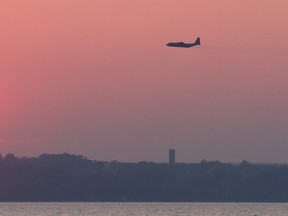 A search and rescue Hercules plane for Trenton flies over the water north of Owen Sound in a different search of Georgian Bay in August 2013. James Masters/The Sun Times