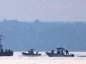 A flotilla of coast guard and O.P.P. boats search Owen Sound Bay for a missing fisherman late in the evening on Tuesday, July 2, 2013.  (The Sun Times/JAMES MASTERS/QMI Agency)