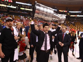 Supplied photo Sudbury's Kyle Davidson, the Chicago Blackhawks'co-ordinator of hockey operations, hoists the Stanley Cup after the team's recent victory.