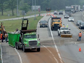 Clean-up crews finish up after a garbage truck flipped on the on-ramp to the Highway 401 eastbound lanes near Prescott this morning. THOMAS LEE The Recorder and Times