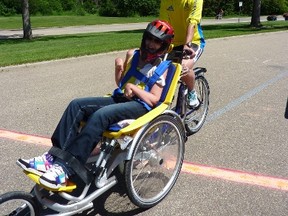 Morrie Ripley pushes Kwad Squad teammate Chandra Round, who has cerebral palsy, as the pair warms up for Sunday’s Great White North triathlon at Allan Beach Resort in Stony Plain. Photo supplied