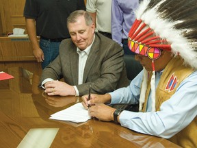 President of ATCO Pipelines, Brendan Dolan(Left) and Ermineskin Chief, Craig Manikaw, both finalizing the deal between the community and the company on June 27