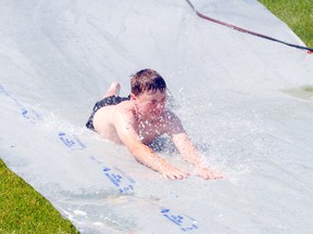 Cameron Woolridge, age 12, from Peace River, cools off on the waterslide at Riverfront Park on Monday July 1, 2013. Temepratures were expected to reach 30 plus degrees.