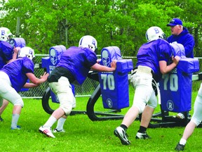 Coach Gord Adams looks on as some Beaver Brae football players go up against the five-man sled during spring training. For the first time ever Beaver Brae will offer a Grade 7 and 8 program this fall to the new students coming into the high school. 
GRACE PROTOPAPAS/KENORA DAILY MINER AND NEWS