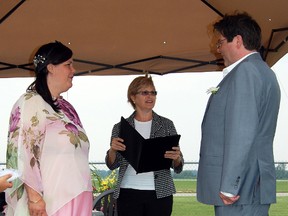 Celebrating their love for Canada and each other on Canada Day seemed the perfect thing to do for Ted and Claire Underhill. The bride and groom said their 'I Do's' in front of family and friends at the Tillsonburg Regional Airport Monday afternoon. The couple were married in a civil ceremony by Town Clerk Donna Willson; centre. 

KRISTINE JEAN/TILLSONBURG NEWS/QMI AGENCY