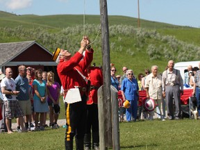 Reid Galbraith, of the North West Mounted Police, raises the flag at the Bar U Ranch National Historic Site on Canada Day