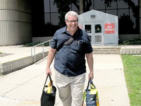 Chris Carter, 46, walks out of the Chatham courthouse during a break in his trial on Wednesday July 3, 2013. Carter is charged with impersonation with intent and disobeying a court order after his arrest in February 2012 involving a matter with Chatham-Kent Children's Services. (VICKI GOUGH, Daily News)