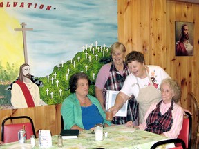 Rosemary Rink, left, receives a coffee from Shepherd's Way Inn volunteer Jane Plant while volunteer Ethel Jennings, holding menu, and restaurant operator Theresa Nadeau, seated, wait to take an order and converse on the day's happenings at the Chatham, Ontario restaurant on Tuesday June 25, 2013. (VICKI GOUGH, Daily News)