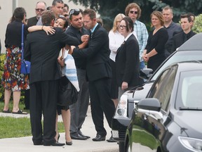 A funeral was held Wednesday for Maximus Huyskens.  The 2 year old boy was left in a  sweltering car  by his grandmother for hours last week. His mother Tamara (clutching his baby blanket) & father Marcus (light blue collar) say good-bye to family & friends , outside of the Holy Rosary Catholic Church in Milton. Stan BehalToronto Sun/QMI Agency