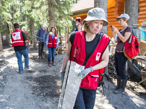 The Canadian Red Cross acted quickly after news spread of the widespread flooding that effected the Calgary area in late June, sending aid, supplies and volunteers to southern Alberta. Of the countless volunteers who moved quickly to offer their assistance, included Laureen Harper (pictured), the wife of Prime Minister Stephen Harper. Also Alberta bound with aid were seven trained emergency volunteers from the Timmins branch of the Canadian Red Cross.