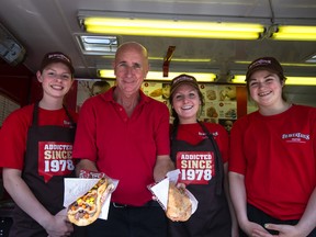 Beaver Tail Trailer owner Denis Thibodeau, a long with Abbey Brown, Courtney Blades and Kate Klein show off some of their treats. 
Sam Koebrich for The Whig-Standard