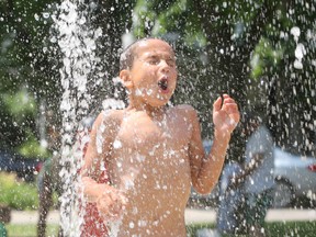 Jett Lajoie cools off at the Provencher spray pad during 32C heat in Winnipeg, Man. Wednesday July 03, 2013. 
BRIAN DONOGH/WINNIPEG SUN/QMI AGENCY